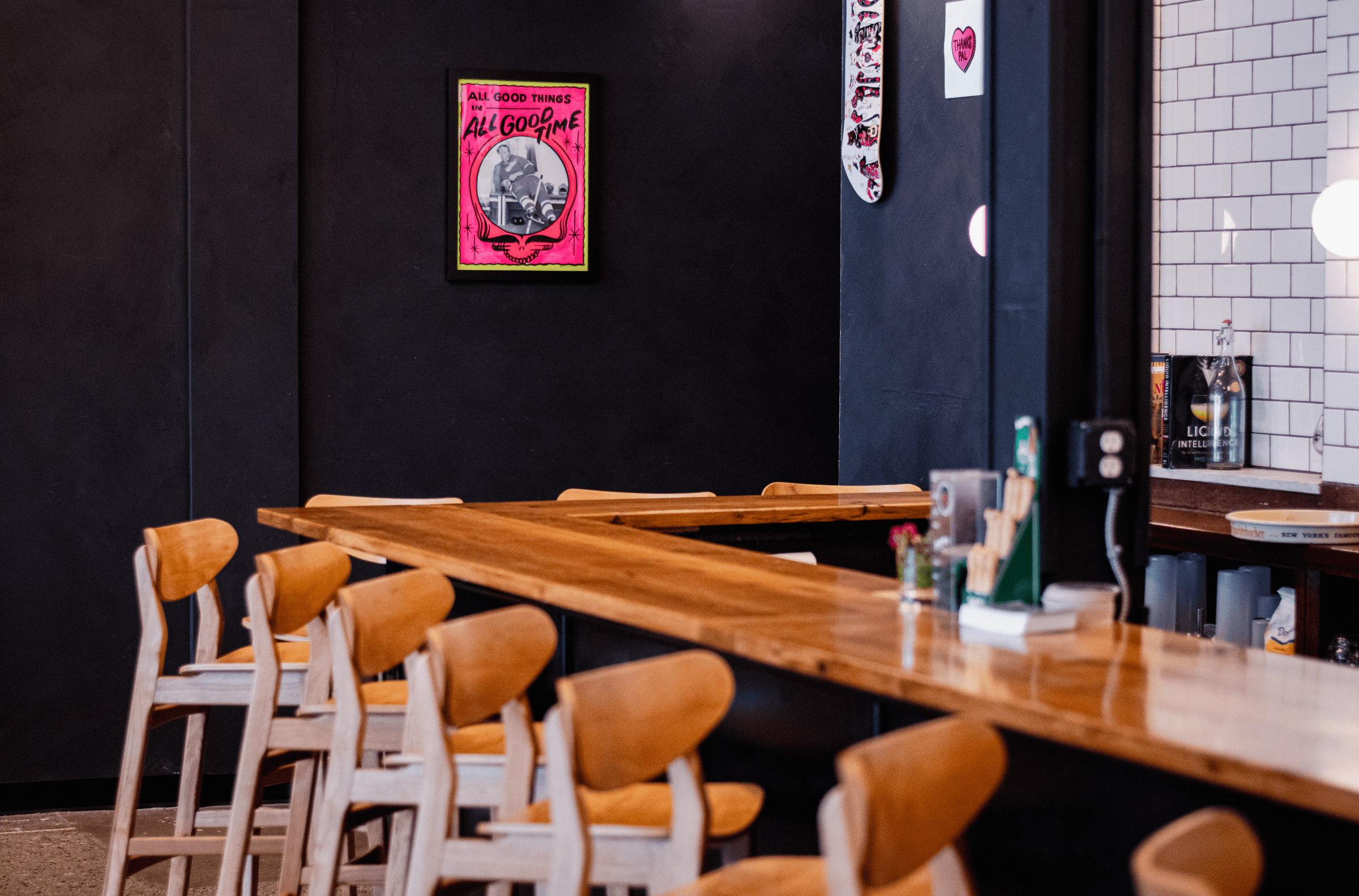 Wooden stools with backs line the bar at Meantime.