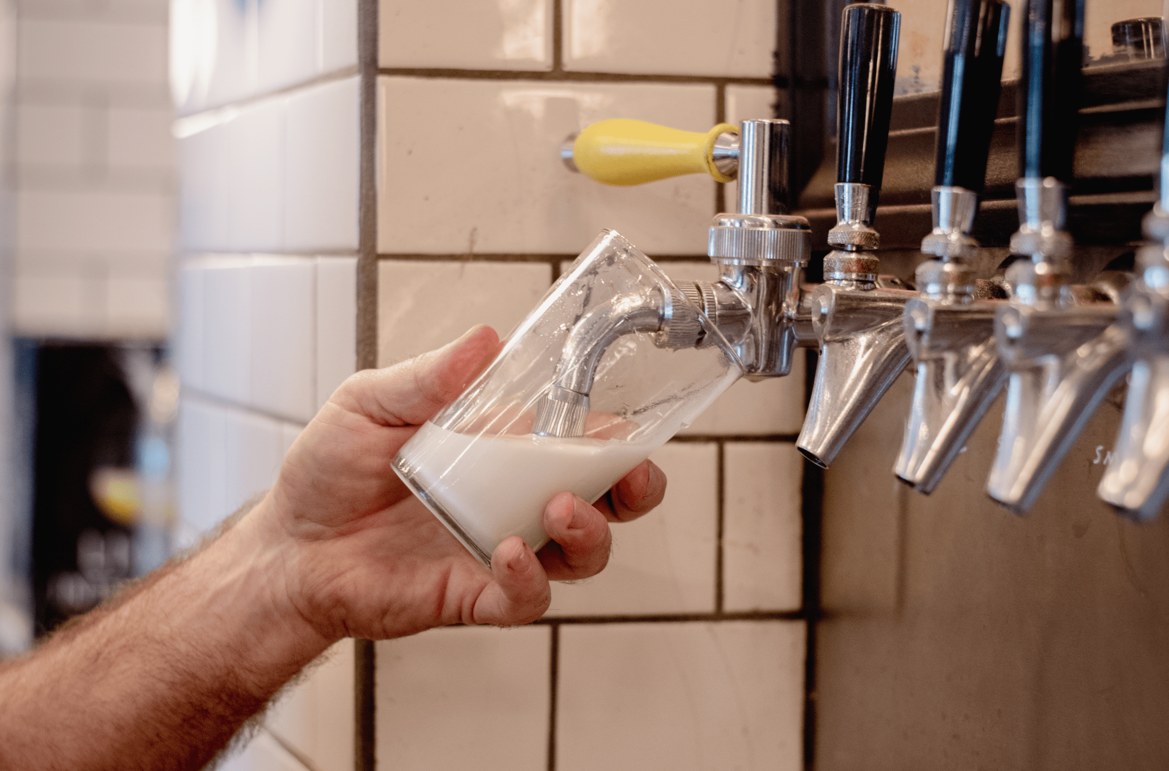 A bunch of foam pours into a clear glass.